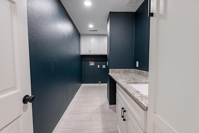 1935 E Canterbury St, Springfield, MO 65804 - laundry room featuring baseboards, recessed lighting, and a sink