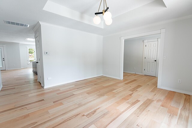 1935 E Canterbury St, Springfield, MO 65804 - spare room featuring a chandelier, light wood-style floors, a raised ceiling, baseboards, and ornamental molding