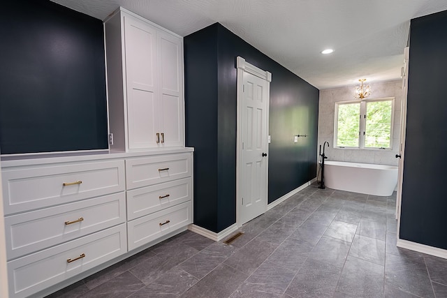 1935 E Canterbury St, Springfield, MO 65804 - full bath with baseboards, a freestanding tub, recessed lighting, and a chandelier