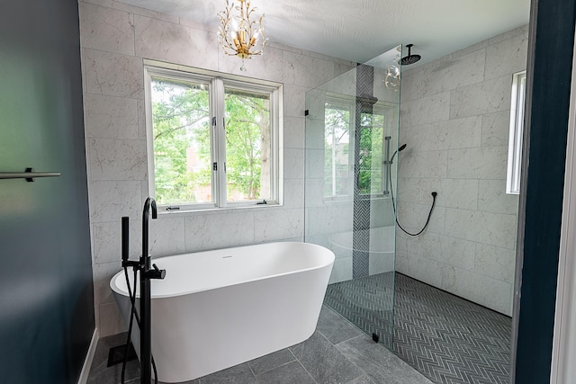 1935 E Canterbury St, Springfield, MO 65804 - full bathroom with plenty of natural light, a freestanding bath, a walk in shower, tile walls, and a chandelier