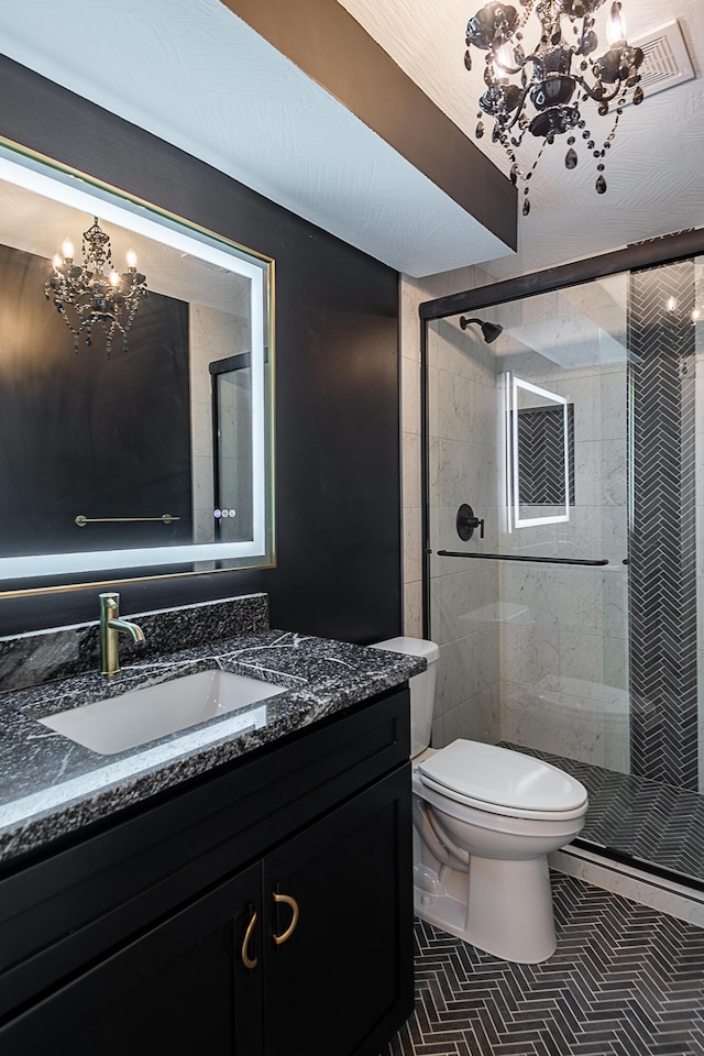1935 E Canterbury St, Springfield, MO 65804 - bathroom with a chandelier, vanity, a stall shower, and toilet