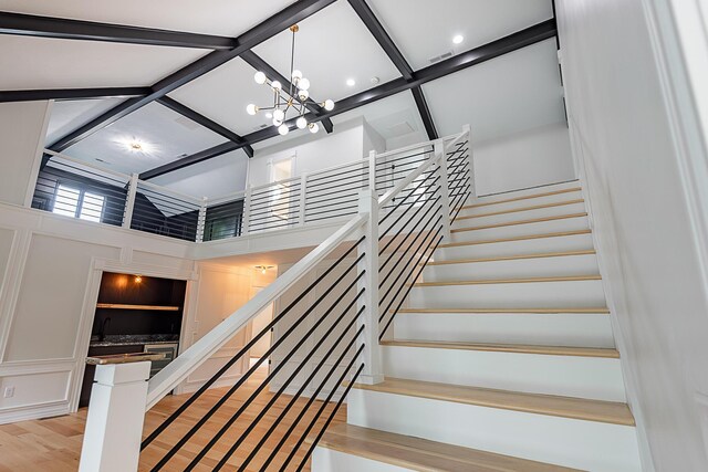 1935 E Canterbury St, Springfield, MO 65804 - staircase with a high ceiling, a chandelier, and wood finished floors