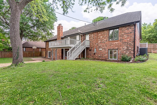 1935 E Canterbury St, Springfield, MO 65804 - back of house featuring a deck, brick siding, stairs, and a chimney