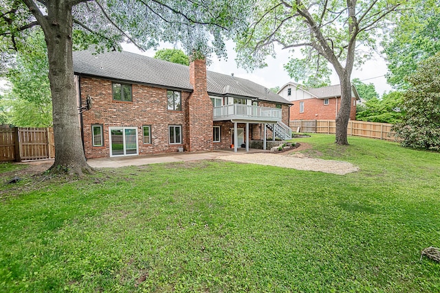 1935 E Canterbury St, Springfield, MO 65804 - rear view of house with stairs, a patio, a chimney, a wooden deck, and brick siding