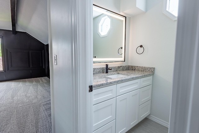 1935 E Canterbury St, Springfield, MO 65804 - bathroom featuring lofted ceiling, vanity, and baseboards