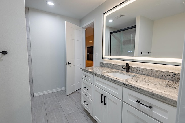 1935 E Canterbury St, Springfield, MO 65804 - bathroom featuring a shower stall, baseboards, vanity, and recessed lighting