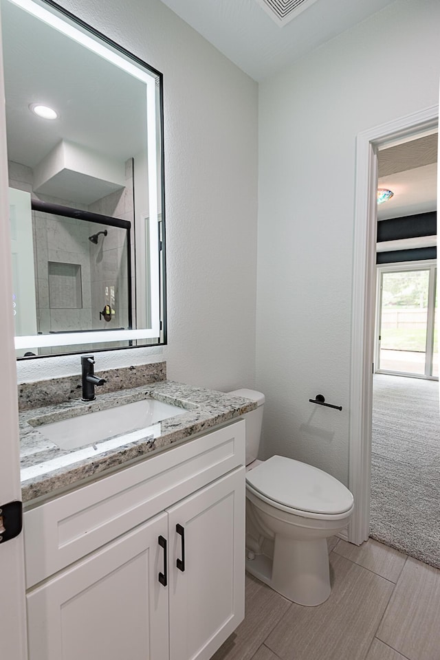 1935 E Canterbury St, Springfield, MO 65804 - full bathroom with a shower stall, vanity, toilet, and wood finished floors