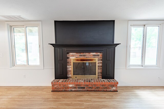 1935 E Canterbury St, Springfield, MO 65804 - detailed view of wood finished floors, a fireplace, and baseboards