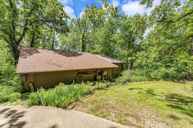 3152 Two Rivers Rd, Highlandville, MO 65669 - view of side of home with a shingled roof and a yard