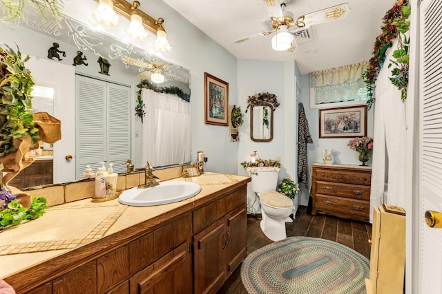 3152 Two Rivers Rd, Highlandville, MO 65669 - bathroom featuring a closet, wood tiled floors, toilet, vanity, and a ceiling fan