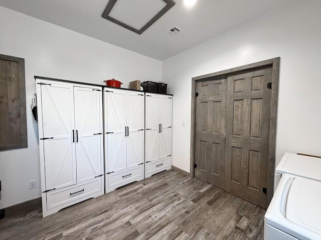 30285 E Pawhuska Rd, El Dorado Springs, MO 64744 - unfurnished bedroom with wood finished floors and washer and clothes dryer