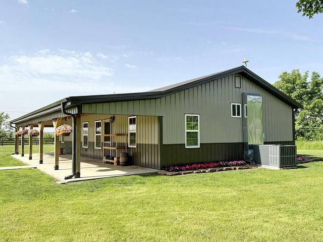 30285 E Pawhuska Rd, El Dorado Springs, MO 64744 - back of house with cooling unit, a patio area, a lawn, and board and batten siding