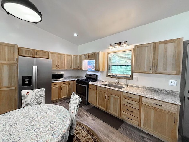 30285 E Pawhuska Rd, El Dorado Springs, MO 64744 - kitchen featuring appliances with stainless steel finishes, a sink, dark wood finished floors, light brown cabinetry, and high vaulted ceiling
