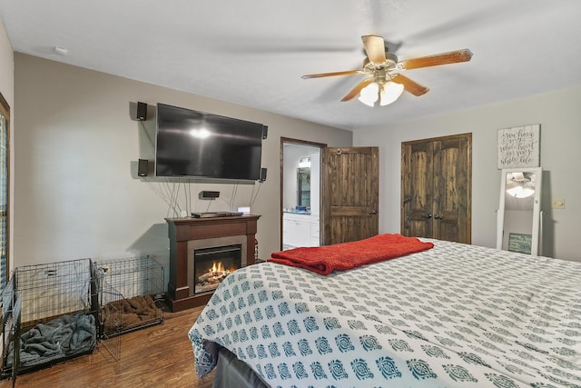 45 Stone Ridge Ct, Strafford, MO 65757 - bedroom featuring wood finished floors, a closet, a glass covered fireplace, ceiling fan, and ensuite bathroom