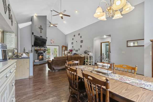 45 Stone Ridge Ct, Strafford, MO 65757 - dining space featuring high vaulted ceiling, a ceiling fan, dark wood-style flooring, a chandelier, and a warm lit fireplace