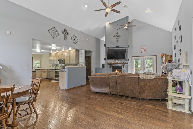45 Stone Ridge Ct, Strafford, MO 65757 - living room with high vaulted ceiling, a ceiling fan, dark wood-style flooring, a lit fireplace, and plenty of natural light