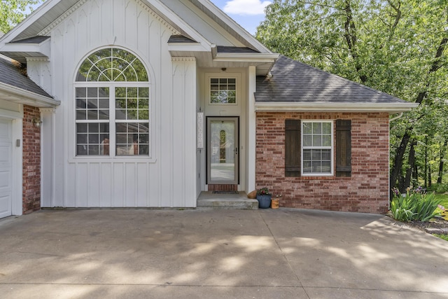 45 Stone Ridge Ct, Strafford, MO 65757 - view of exterior entry featuring brick siding, a shingled roof, and board and batten siding
