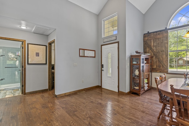 45 Stone Ridge Ct, Strafford, MO 65757 - entrance foyer featuring plenty of natural light, wood finished floors, baseboards, high vaulted ceiling, and a barn door