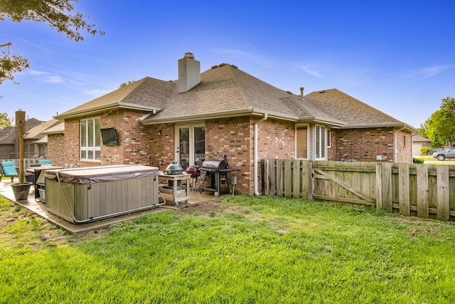 1166 W Shawnee St, Springfield, MO 65810 - rear view of property with a hot tub, brick siding, a shingled roof, a patio, and a chimney