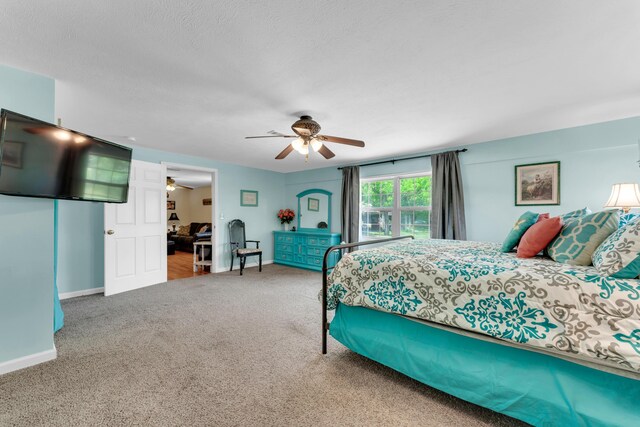 301 Lake Dr, Branson, MO 65616 - bedroom with carpet floors, baseboards, and a ceiling fan