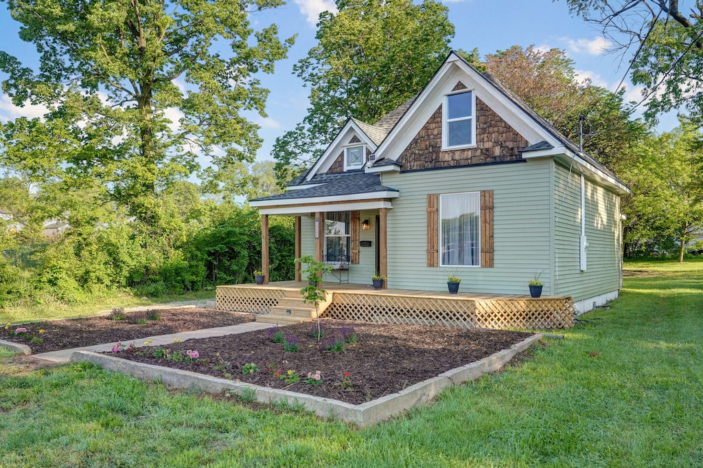 1301 E Locust St, Springfield, MO 65803 - view of front of home with a porch, a front yard, and a shingled roof