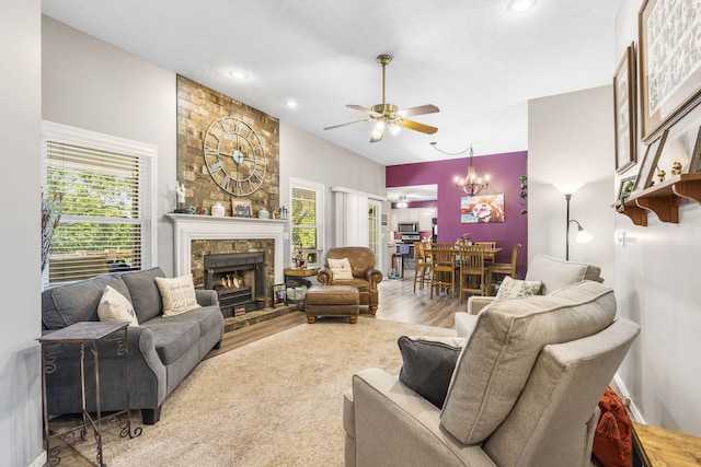1163 S Gregg Rd, Nixa, MO 65714 - living area with a ceiling fan, a warm lit fireplace, recessed lighting, wood finished floors, and a chandelier
