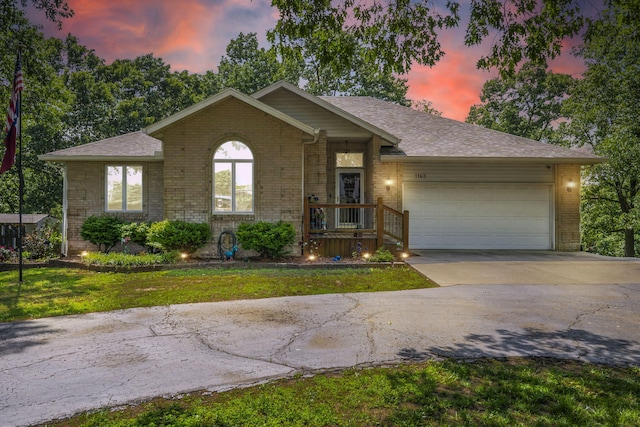 1163 S Gregg Rd, Nixa, MO 65714 - single story home with brick siding, concrete driveway, a garage, and a lawn