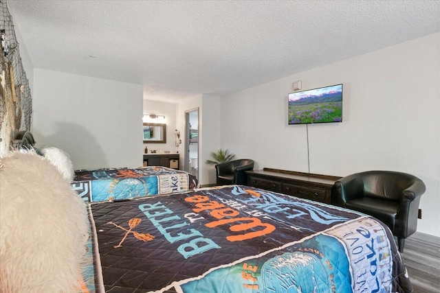 91 Moongate Dr, Osage Beach, MO 65065 - bedroom with a textured ceiling, wood finished floors, and connected bathroom