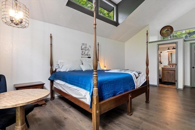 91 Moongate Dr, Osage Beach, MO 65065 - bedroom with lofted ceiling, wood finished floors, a textured ceiling, a chandelier, and ensuite bathroom
