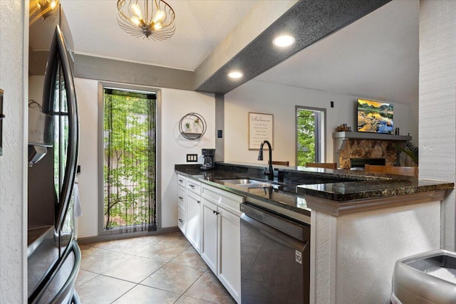 91 Moongate Dr, Osage Beach, MO 65065 - kitchen with black appliances, a sink, dark stone countertops, white cabinetry, and a peninsula