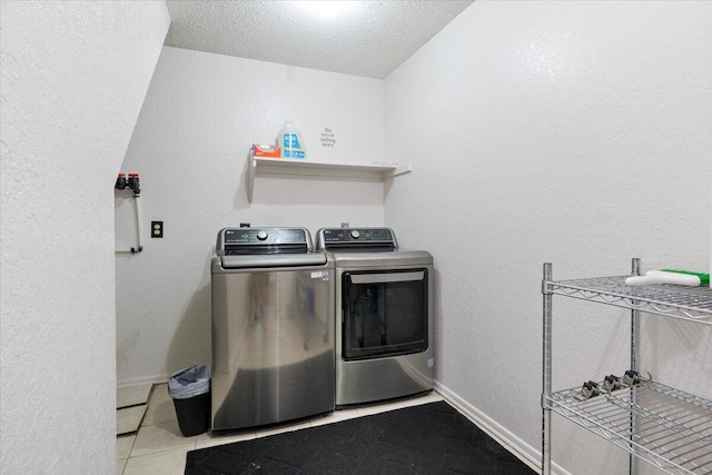 91 Moongate Dr, Osage Beach, MO 65065 - clothes washing area with separate washer and dryer, a textured ceiling, tile patterned floors, baseboards, and a textured wall