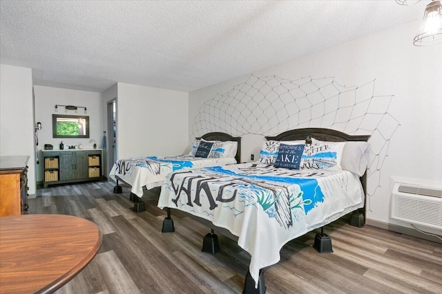 91 Moongate Dr, Osage Beach, MO 65065 - bedroom with wood finished floors, an AC wall unit, and a textured ceiling