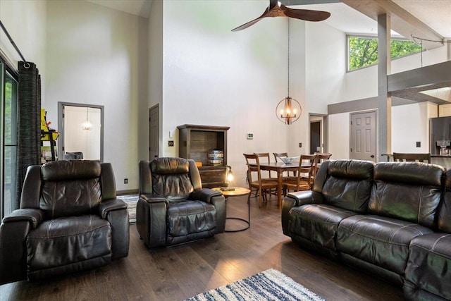 91 Moongate Dr, Osage Beach, MO 65065 - living room featuring high vaulted ceiling, dark wood-style flooring, a ceiling fan, a chandelier, and healthy amount of natural light
