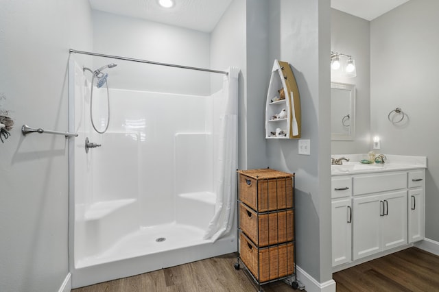 233 Siena Blvd, Branson, MO 65616 - bathroom featuring wood finished floors, a shower with shower curtain, vanity, and baseboards