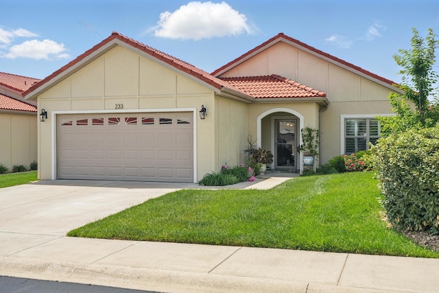233 Siena Blvd, Branson, MO 65616 - mediterranean / spanish-style house featuring a tiled roof, a garage, a front yard, driveway, and stucco siding