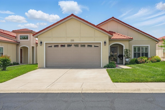 233 Siena Blvd, Branson, MO 65616 - mediterranean / spanish-style home featuring a tile roof, an attached garage, a front yard, and driveway
