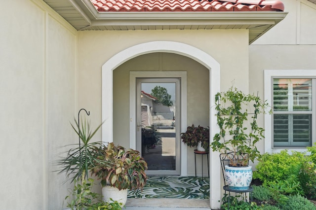 233 Siena Blvd, Branson, MO 65616 - doorway to property featuring stucco siding and a tile roof