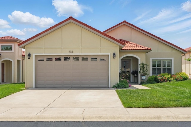 233 Siena Blvd, Branson, MO 65616 - mediterranean / spanish house with a tiled roof, an attached garage, concrete driveway, and stucco siding