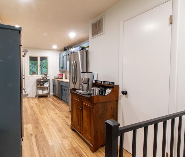 5312 S Hawthorne Dr, Springfield, MO 65804 - kitchen featuring light wood finished floors, appliances with stainless steel finishes, recessed lighting, light countertops, and blue cabinets