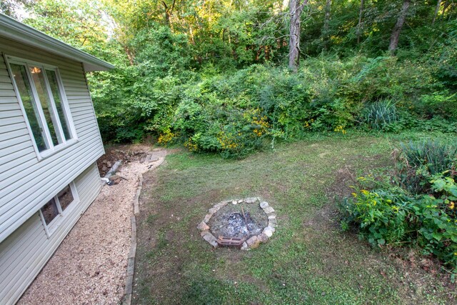 5312 S Hawthorne Dr, Springfield, MO 65804 - view of yard with a fire pit and a wooded view