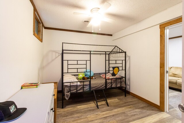 5312 S Hawthorne Dr, Springfield, MO 65804 - bedroom with light wood-style flooring, a textured ceiling, and baseboards