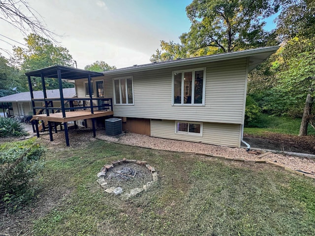 5312 S Hawthorne Dr, Springfield, MO 65804 - rear view of house with cooling unit, a wooden deck, and an outdoor fire pit