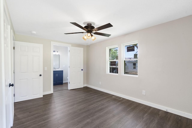1827 N Tyler Ave, Springfield, MO 65802 - unfurnished bedroom featuring dark wood-type flooring, baseboards, connected bathroom, and ceiling fan