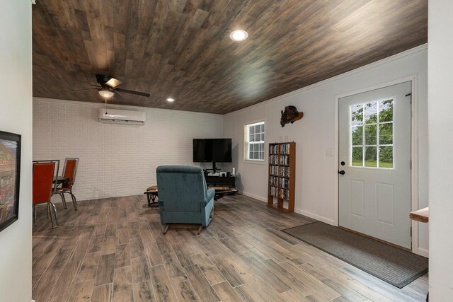 296 Lodgepole Dr, Ozark, MO 65721 - sitting room with a wall mounted air conditioner, brick wall, wooden ceiling, crown molding, and wood finished floors
