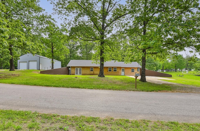 296 Lodgepole Dr, Ozark, MO 65721 - ranch-style home featuring a detached garage, a front lawn, and view of wooded area