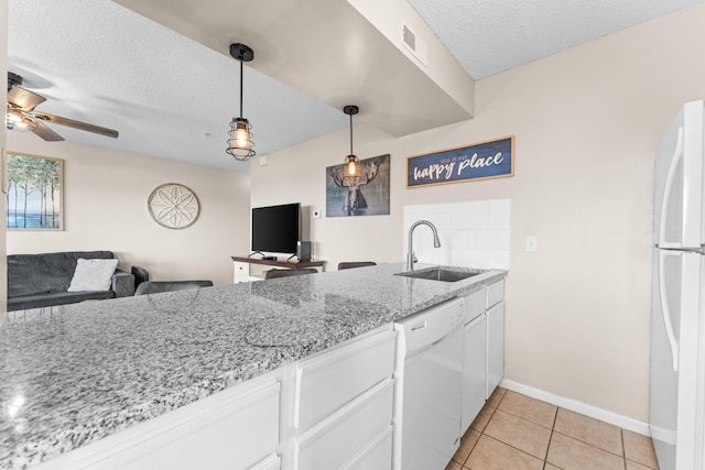 13 Treehouse Ln Unit 4, Branson, MO 65616 - kitchen with white appliances, a sink, open floor plan, white cabinets, and a textured ceiling