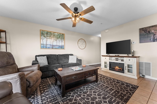 13 Treehouse Ln Unit 4, Branson, MO 65616 - tiled living room with ceiling fan, baseboards, and a glass covered fireplace