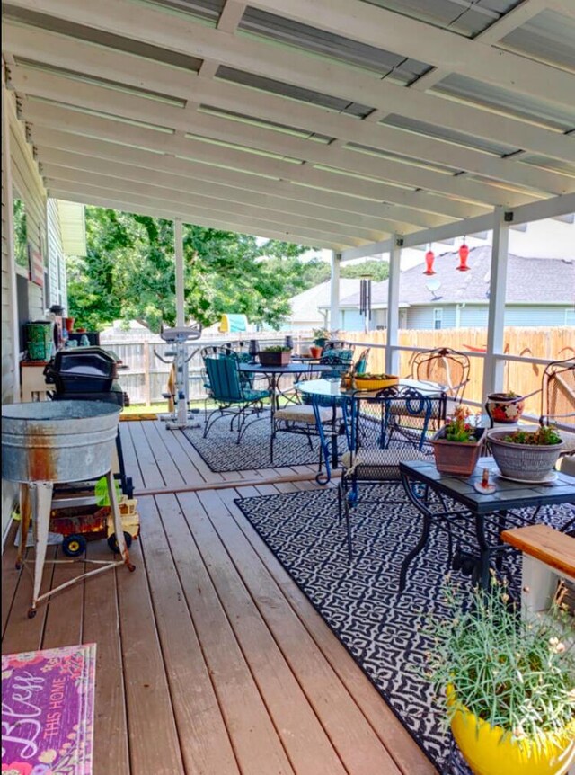 1810 Meadows Dr, Neosho, MO 64850 - wooden terrace with outdoor dining area and fence