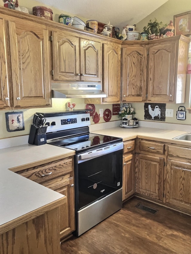 1810 Meadows Dr, Neosho, MO 64850 - kitchen with under cabinet range hood, stainless steel range with electric stovetop, dark wood-type flooring, and light countertops
