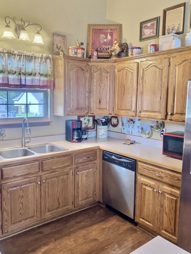 1810 Meadows Dr, Neosho, MO 64850 - kitchen featuring appliances with stainless steel finishes, a sink, light countertops, and dark wood-style flooring